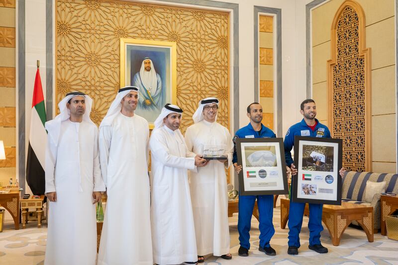Sheikh Mansour bin Zayed receives a gift from staff of the Mohammed bin Rashid Space Centre, at Qasr Al Watan on Thursday. Photo: Presidential Court