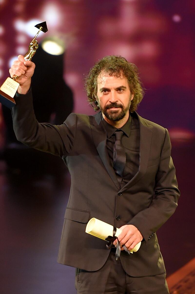 Uruguayan director Alvaro Brechner holds the golden pyramid award for Best Director