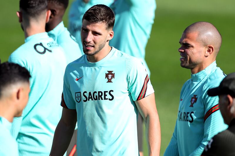 Ruben Dias, centre, and Pepe train in Oeiras for the World Cup qualifier against Serbia. EPA