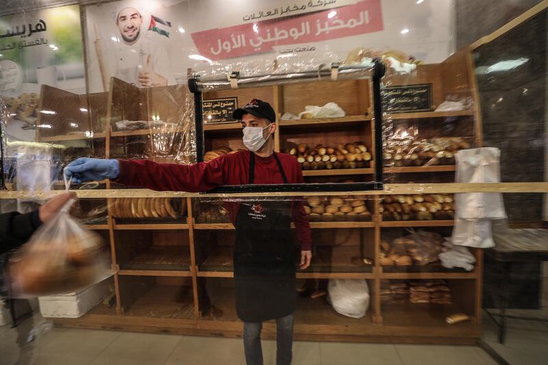 A bakery worker wears a facemask during his work at the family bakery as a precaution against the spread of the Covid-19 coronavirus in Gaza City. EPA