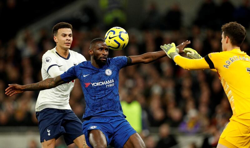 Tottenham Hotspur's Dele Alli is held off by Antonio Rudiger of Chelsea. Reuters