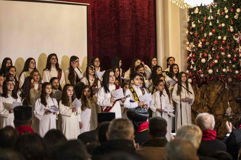 Children sing Christmas carols at the Syriac Orthodox Church of the Virgin Mary in Qamishli in northeastern Syria.  AFP