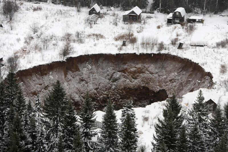 An aerial view of a giant sinkhole in Russia’s Perm region, near Solikamsk. The crater appeared in November and continues to grow, swallowing more houses. EPA
