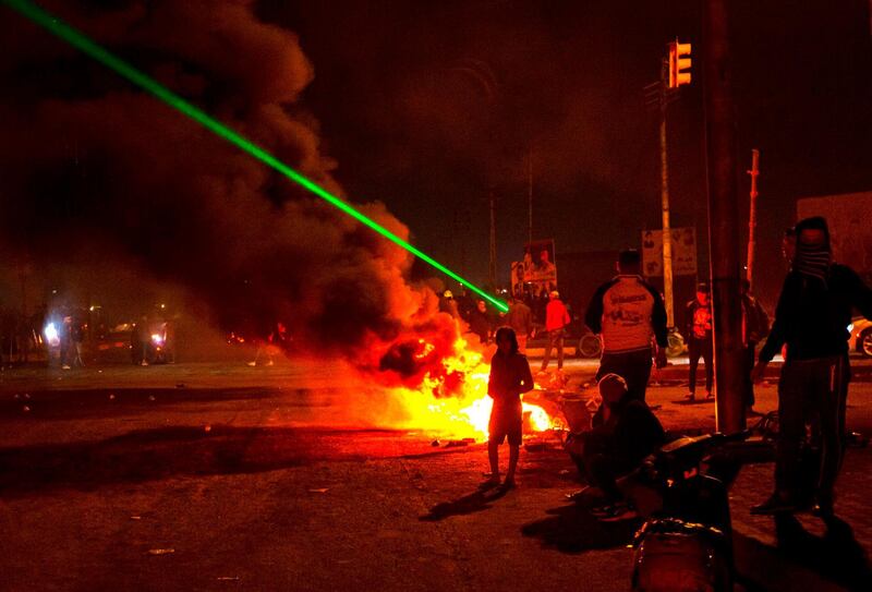 Iraqi anti-government protesters block a road with burning tyres in the southern Iraqi city of Basra. AFP