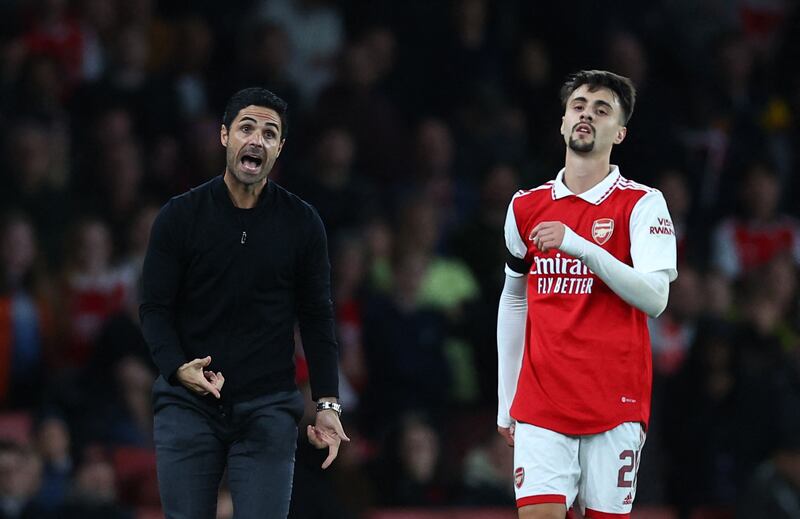 Arsenal manager Mikel Arteta reacts as Fabio Vieira passes by. Reuters