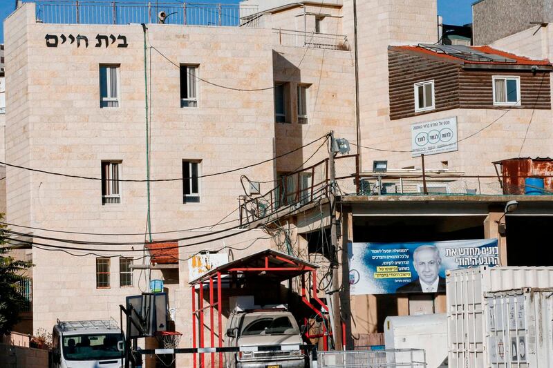 A banner depicting the portrait of Israeli Prime Minister Benjamin Netanyahu with text in Hebrew (R) reading "Rebuilding the Jewish Quarter 'The Market' in Hebron", hanging on an old market building along al-Shuhada street in the flashpoint city of Hebron. AFP