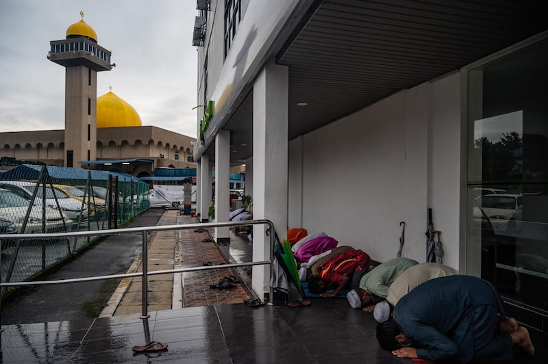 Muslims offer prayers outside a mosque in Kuala Lumpur, Malaysia. AFP