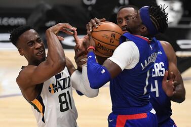 Miye Oni (81) of the Utah Jazz grimaces as he reaches for the ball against Reggie Jackson (1) of the LA Clippers. AP