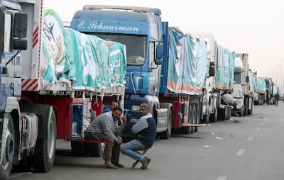 A convoy of aid lorries waits on the road about 300km east of the Egyptian border with Gaza, on its way to the Rafah crossing. EPA 