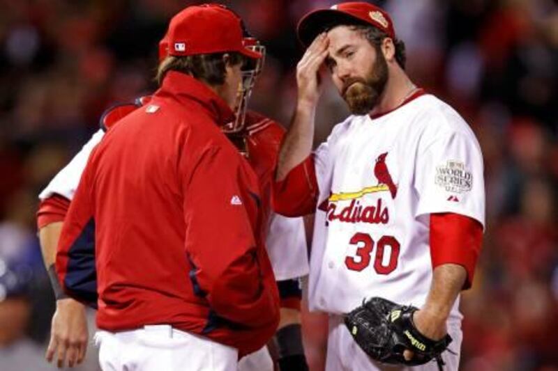 St. Louis Cardinals relief pitcher Jason Motte (R) reacts as manager Tony La Russa takes him from the game in the ninth inning of play against the Texas Rangers in Game 2 of MLB's World Series baseball championship in St. Louis, Missouri, October 20, 2011.  REUTERS/Jeff Haynes (UNITED STATES  - Tags: SPORT BASEBALL) *** Local Caption ***  STL151_BASEBALL-SER_1021_11.JPG