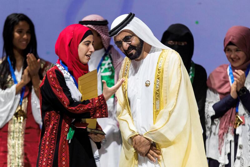 Dubai, United Arab Emirates, October 18, 2017:    Sheikh Mohammed bin Rashid Al Maktoum Prime Minister and Vice President of the United Arab Emirates and Ruler of Dubai listens to Afaf Sharef, 17, from Palestine after he awarded her the trophy for winning the Arab Reading Challenge, receiving Dh550,000 in prize money, during the final ceremony at the Dubai Opera in the Emaar Square area of Dubai on October 18, 2017. Christopher Pike / The National

Reporter: Nawal
Section: News