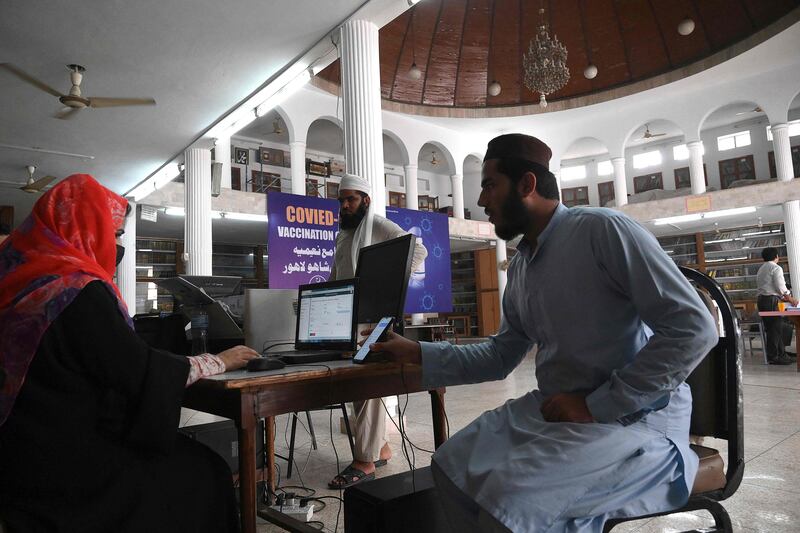 Students register their details at the Jamia Naeemia clinic in Peshawar. AFP