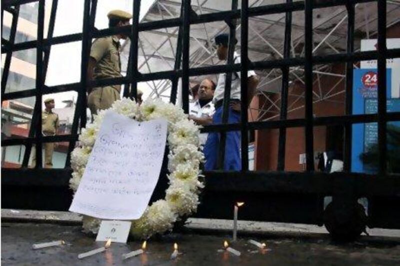 A memorial wreath with a note attached is placed outside the Advance Medicare And Research Institute (AMRI) hospital Saturday after deadly fire Friday which killed 90 people in Kolkata, India.