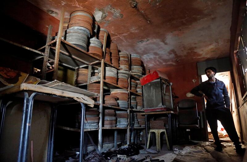 A Palestinian worker looks at materials in the remaining part of an abandoned cinema in Tulkarm, in the Israeli-occupied West Bank. Reuters