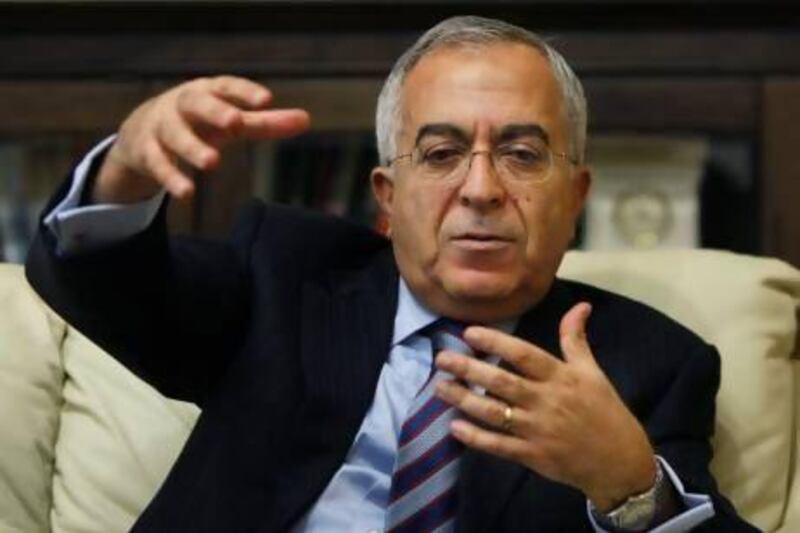 Palestinian Prime Minister Salam Fayyad gestures during an interview with The Associated Press in the West Bank city of Ramallah, Sunday, Jan. 6, 2013. Fayyad is blaming Arab countries that havenít delivered promised financial aid for an escalating financial crisis in the Palestinian territories. In an interview Sunday Fayyad said that the cash crunch is pushing an additional 25 percent of the Palestinian population, or 1 million people, into poverty. (AP Photo/Majdi Mohammed) *** Local Caption *** Mideast Israel Palestinians.JPEG-0569a.jpg