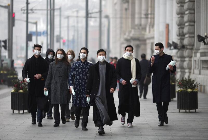 A group of expatriates walk along the Bund in January as they distribute face masks to pedestrians to raise awareness of air pollution in downtown Shanghai. Carlos Barria / Reuters