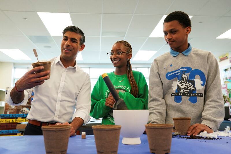 Rishi Sunak takes part in a sustainability project during a high school visit. Reuters