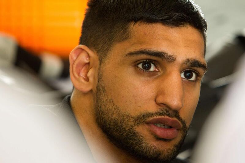 Amir Khan looks on as he gets his hands wrapped during a workout session at Virgil Hunter’s Gym on April 24, 2014 in Hayward, California. Kahn is preparing to take on Luis Collazo at the MGM Grand in Las Vegas on May 3, 2014. Alexis Cuarezma/Getty Images/AFP