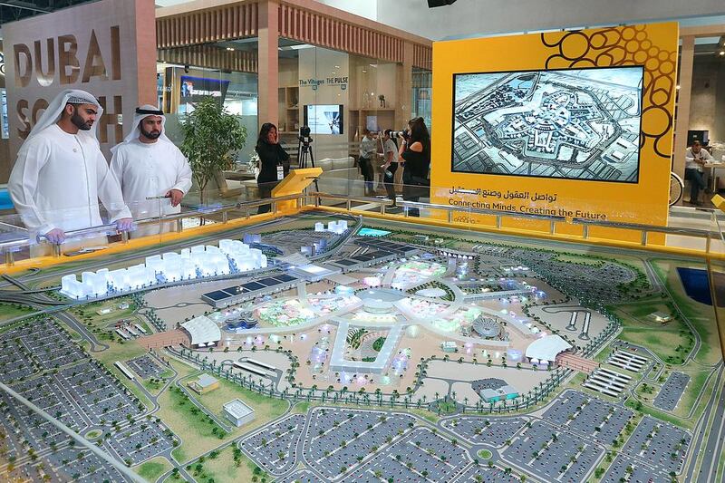 Visitors look at the model of the Expo 2020 site at the Cityscape Global. Satish Kumar / The National