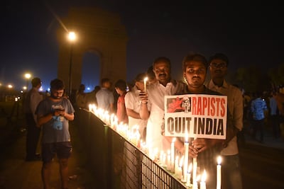 Indian demonstrators gather at the India Gate monument for a late night candlelight vigil in protest over the gang rape and murder of an eight-year-old girl, in New Delhi on April 13, 2018.
The brutal gang rape and murder of an eight-year-old girl triggered nationwide outrage in India on April 13 that put the authorities under new pressure over the scourge of sexual crimes.  
 / AFP PHOTO / -