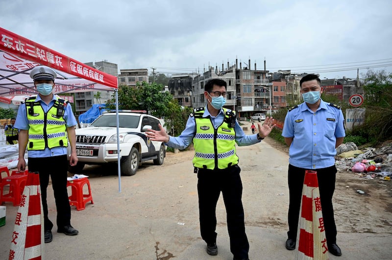 Policemen guard a checkpoint at Langnan village, in Wuzhou, near where Flight MU5375 crashed. AFP
