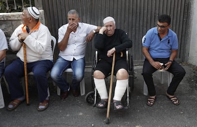 Members of the Shamasneh family who are being evicted from their home in which they lived for over half a century, watch as Israeli policemen evacuate their house in an Arab neighbourhood in east Jerusalem, on September 5, 2017.
The Shamasneh family has for years been fighting a court battle against Jewish claimants who said that the building was their family property, which they fled when east Jerusalem was occupied by Jordanian troops in the 1948 war that led to the creation of the Jewish state. Under Israeli law, if Jews can prove their families lived in east Jerusalem homes before the 1948 war they can demand that Israel's general custodian office release the property and return their "ownership rights". / AFP PHOTO / Ahmad GHARABLI