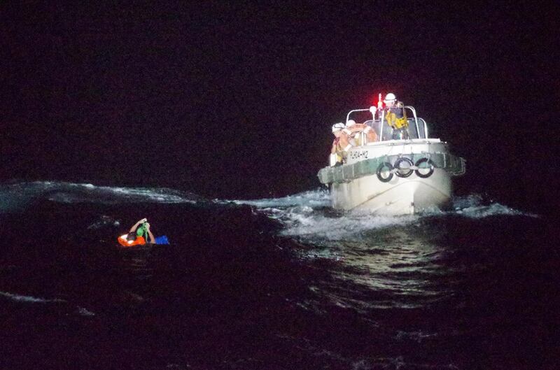 A Filipino crew member believed to be onboard 'Gulf Livestock 1' is rescued by a Japanese coastguard team to the west of Amami Oshima island in south-west Japan. Reuters