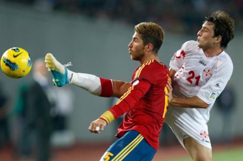 Sergio Ramos battles for the ball with Nika Dzalamidze during Spain's World Cup 2014 qualifying match against Georgia in Tblisi