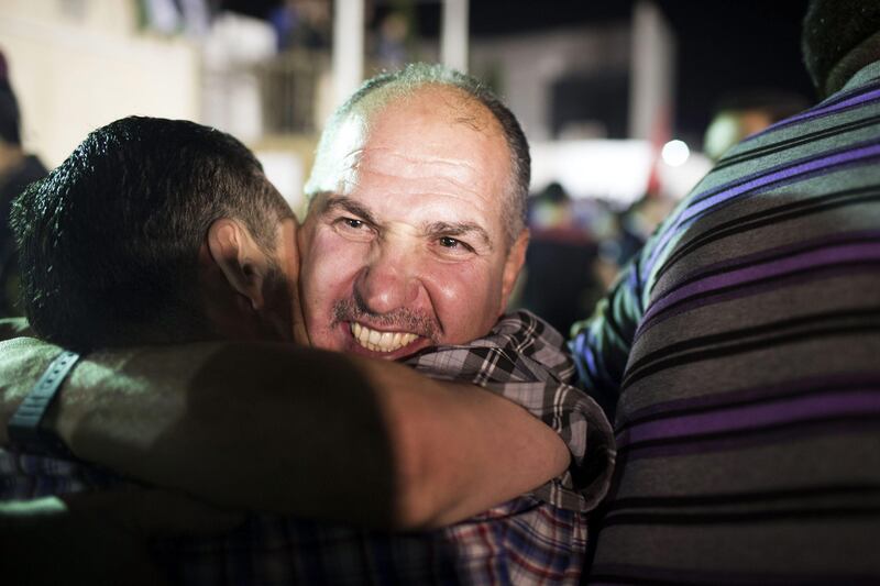 RAMALLAH, WEST BANK - AUGUST 14: A Palestinian prisoner released from an Israeli jail hugs his supporters in the Mikatah compound on August 14, 2013 in Ramallah, West Bank. Israel announced that 26 Palestinian prisoners will be released, 15 to Gaza and 11 sent to West Bank, as part of Israeli-Palestinian negotiations. (Photo by Ilia Yefimovich/Getty Images) *** Local Caption ***  176475865.jpg