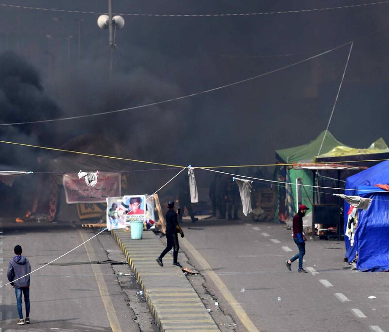 epa08162782 Iraqi anti-riot police forces burn the protesters' tents at Tahrir square in central Baghdad.  EPA