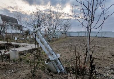 A part of a rocket is seen in a garden of private house in partially blocked by Russian troops city of Chernihiv. EPA