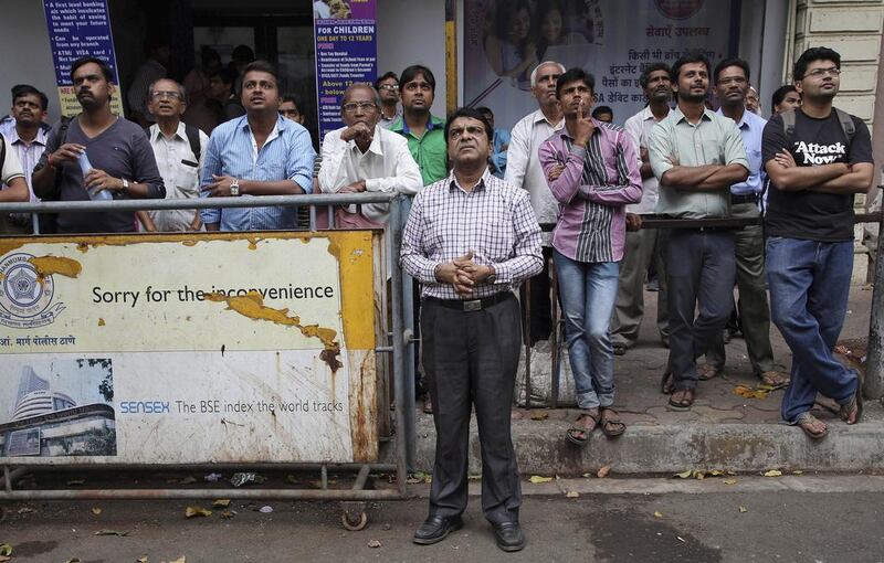 A reader pins hopes on the new Indian budget unveiled on Saturday. Above, people watch a display screen at the Bombay Stock Exchange. Rajanish Kakade / AP Photo

