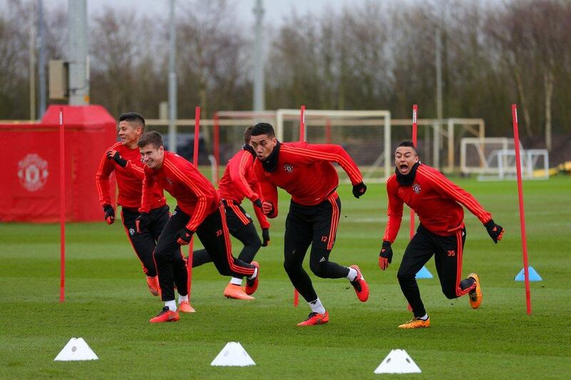 (L-R) Marcos Rojo, Paddy McNair, Chris Smalling and Jesse Lingard of Manchester United run during a training session ahead of the Uefa Europa League round of 16 first leg match between Liverpool and Manchester United at Aon Training Complex on March 9, 2016 in Manchester, England.  (Photo by Dave Thompson/Getty Images)