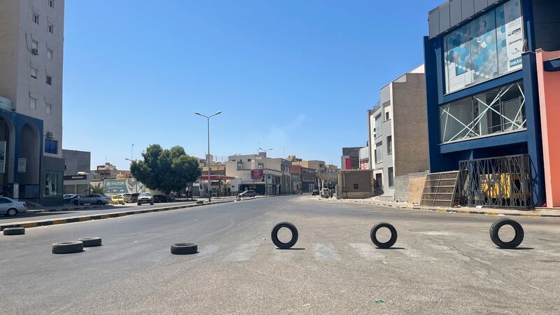 Tyres are used to section off a road in Tripoli. AFP