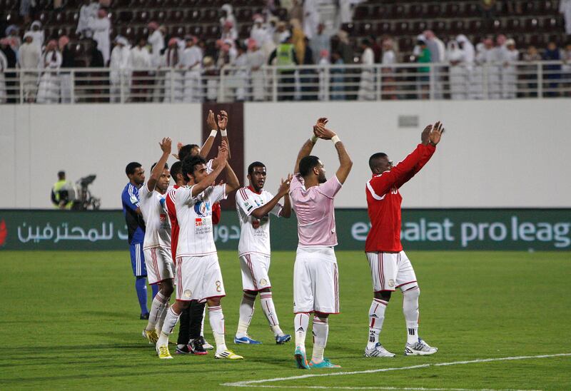 Abu Dhabi, United Arab Emirates, Dec 15 2012, Al Nahyan Stadium Abu Dhabi- (left Blue jacket)  Al Jazira's celebrate with their fans after the match with Al Wahda at Al Nahyan Stadium in Abu Dhabi. Mike Young / The National??