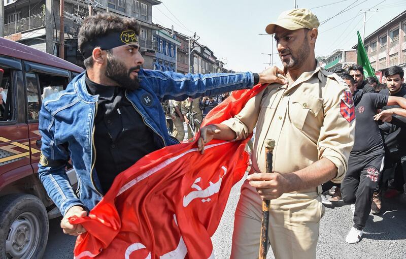 A Kashmiri Muslim is detained by Indian police as devotees defy restrictions for a Muharram procession in Srinagar.  AFP