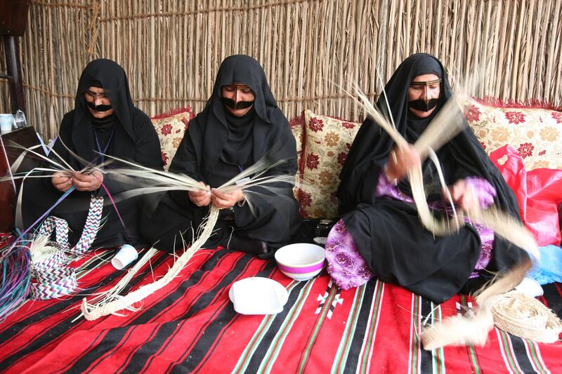 RAS AL KHAIMAH, UNITED ARAB EMIRATES - MARCH 6:  Women weaving at the Al Haboos Arts & Folks Society tribal festival which is held to showcase and preserve the culture of the Al Haboos mountain tribe through poetry, cooking, singing and dancing, in Ras Al Khaimah on March 6, 2010. Pictured from left: Aisha Ali, Aisha Sulaiman and Aisha Mohammed. (Randi Sokoloff / The National)  For News