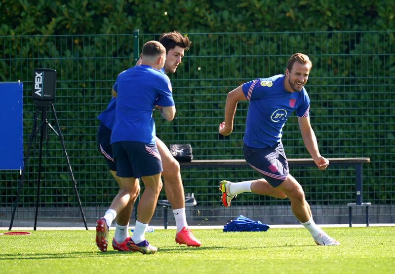 England's Kieran Trippier, Harry Maguire and Harry Kane during a training session at Hotspur Way. PA