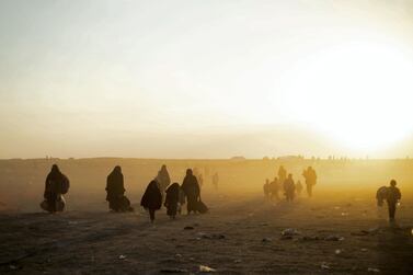 Women and children evacuated from ISIS's embattled holdout of Baghouz arrive at a screening area held by the US-backed Kurdish-led Syrian Democratic Forces (SDF), in the eastern Syrian province of Deir Ezzor. AFP