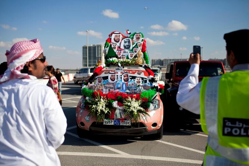 People join in celebration and show off their decorated cars during the Spirit of Union Parade on Thursday evening, Dec. 1, 2011, at the Yas Island near Abu Dhabi. (Silvia Razgova/The National)
