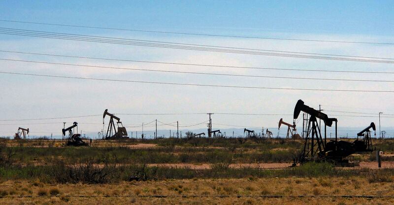 Oil rigs stand in New Mexico. Several banks and energy consultancies have reduced their oil price expectations for the year. AP