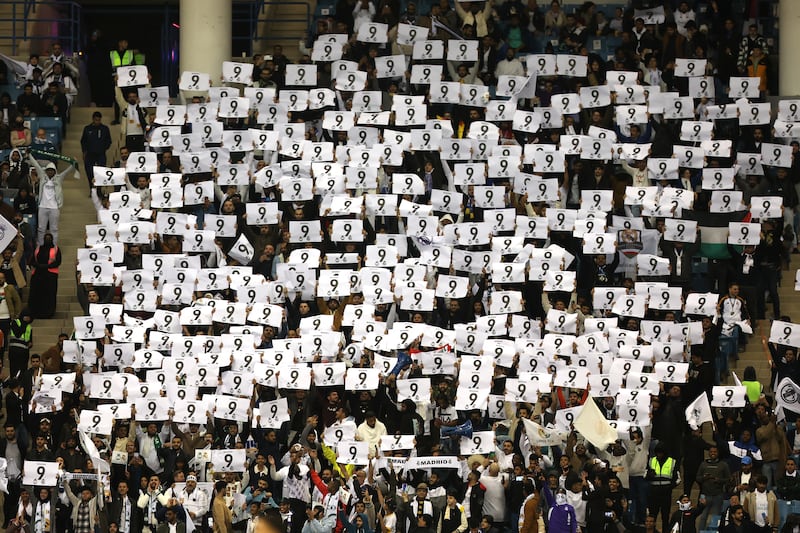 Fans hold up signs with the number of Real's Karim Benzema. Getty