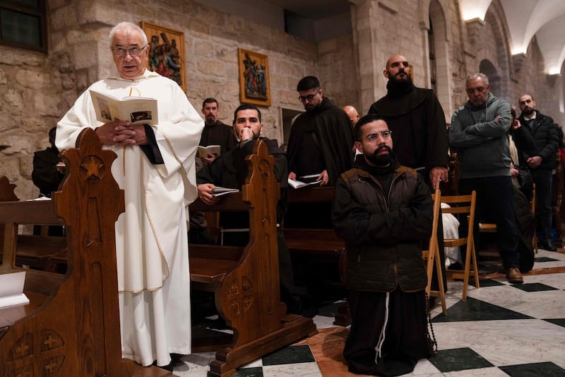 Members of the clergy attend the Christmas midnight Mass at the Church of the Nativity compound in Bethlehem, in the occupied West Bank. AFP