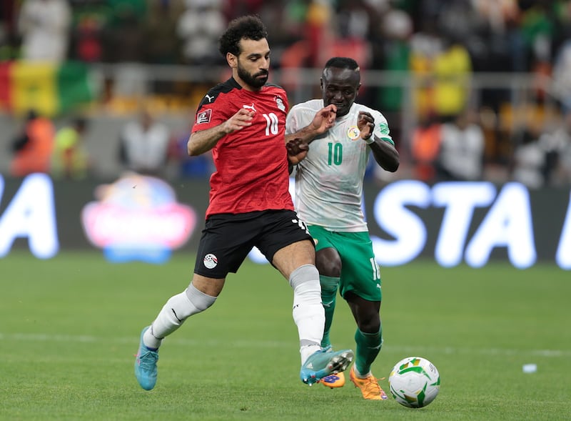 Egypt's Mohamed Salah and Sadio Mane of Senegal battle for the ball during the World Cup qualifier at the Diamniadio Olympic Stadium in Dakar on March 29, 2022. EPA