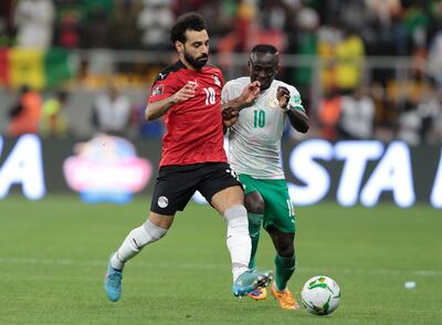 Mohamed Salah (L) of Egypt vies for the ball with Sadio Mane (R) of Senegal during the qualifying match at the Diamniadio Olympic Stadium in Dakar, Senegal, March 29, 2022. EPA