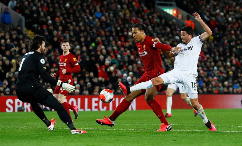 West Ham United's Pablo Fornals in action with Liverpool's Virgil van Dijk and Alisson. Reuters