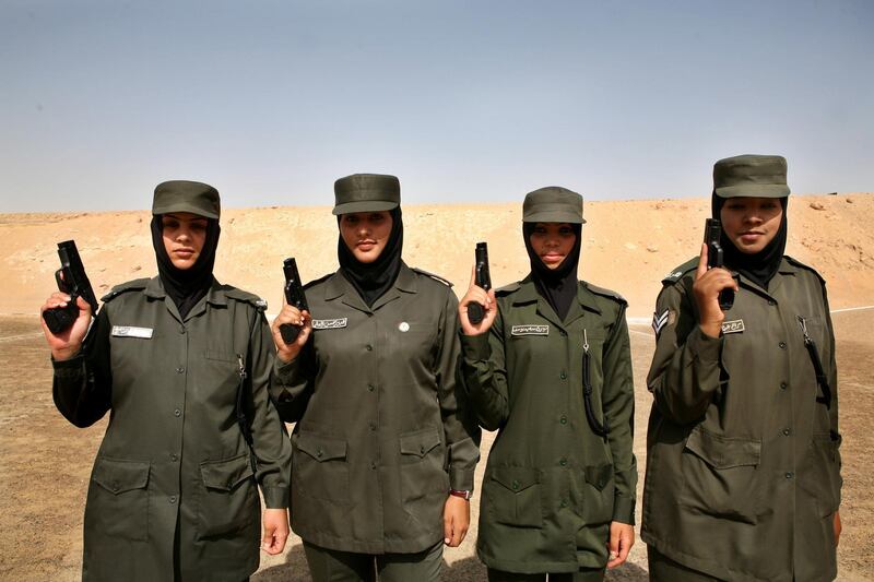 Abu Dhabi - April 7, 2008 - Maryam Almass, 21,  (4th from right); Nora Said, 21, (3rd from right); Abeer Hassan (2nd from right), Fatima Saif, 30, (1st from right) pose for a portrait. Their team came in 3rd place among 25 women shooters. Abu Dhabi police participate in a 3-day shooting match. Four teams of officers from human resources, administration departments and the general department for security are competing. (Nicole Hill / The National) *** Local Caption *** NH SHOOTERS0025.JPG