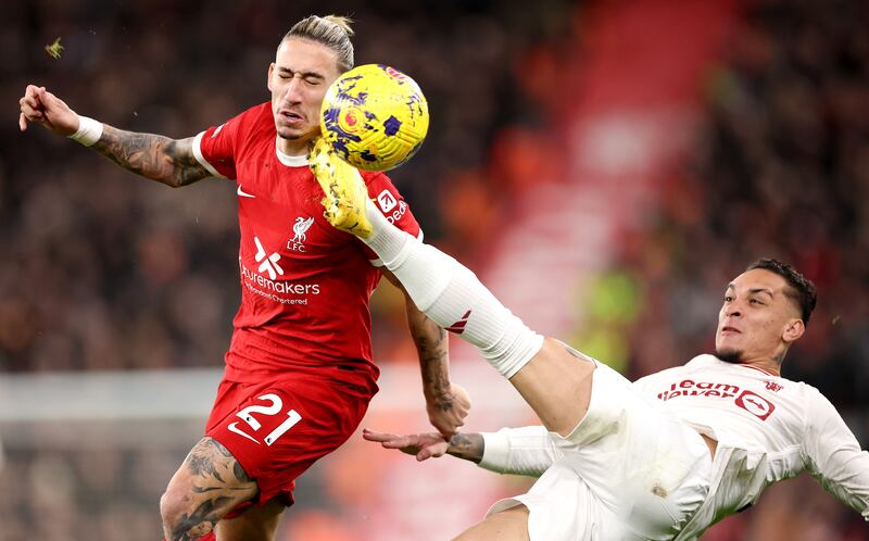 Kostas Tsimikas of Liverpool in action against Antony of Manchester United. EPA