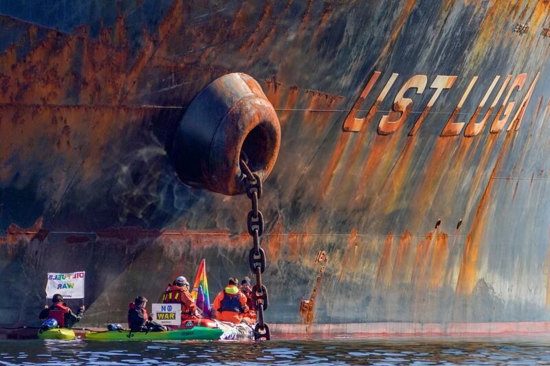 Members of Greenpeace sail next to the "Ust Luga" tanker in a protest against the delivery of Russian oil to Norway. Reuters