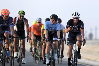 Lance Armstrong rides with Dubai cyclists at the Al Qudra cycling track. Chris Whiteoak / The National